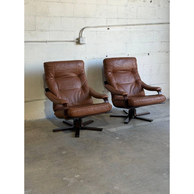 These seating pieces feature contoured high-back frames with plush armrests and a smooth swivel base. Their ergonomic form...