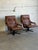 These seating pieces feature contoured high-back frames with plush armrests and a smooth swivel base. Their ergonomic form...