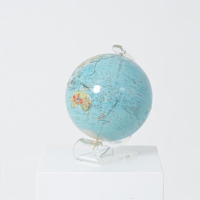 This globe functions as a subtle table lamp. The globe itself is mounted on a bent acrylic glass stand and fitted on the...