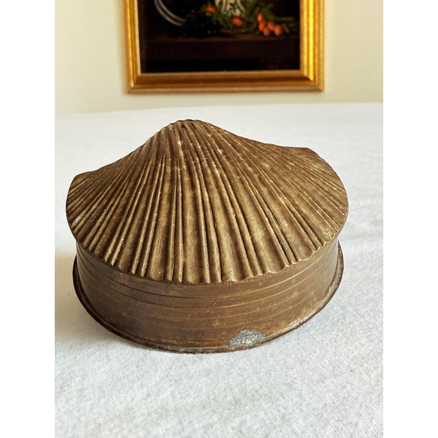 Vintage brass hinged keepsake box cast in the form of a natural seashell, with sculptural ridges and a warm aged brass...