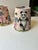 A pair of lampshades handmade from a charming scene of kids dancing and gardening with a panda. Measurements: top 4”...