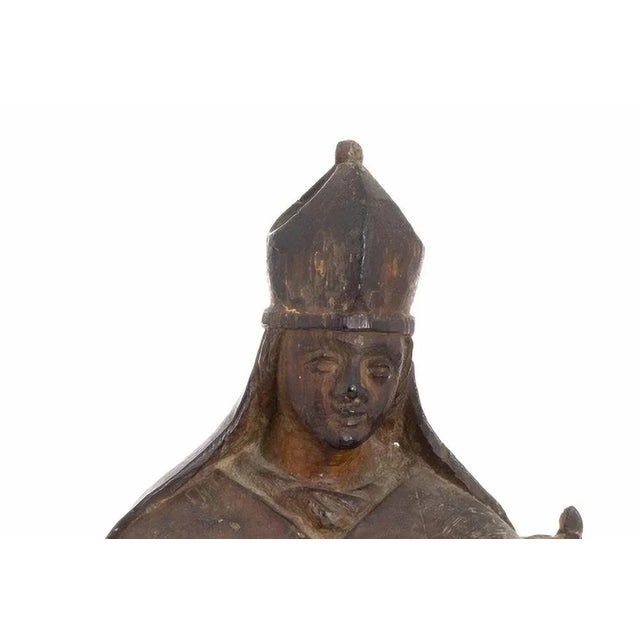 Saint Ambrosius Italian sculpture 17th century in painted and gilded wood. The figure is represented standing up blessing...