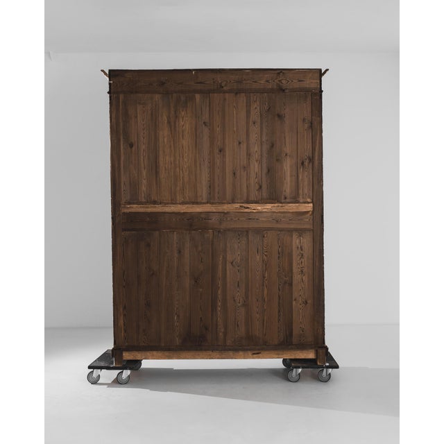 Impressive in stature, this 1900s French Wood Patinated Vitrine invites attention with its slender yet elongated...