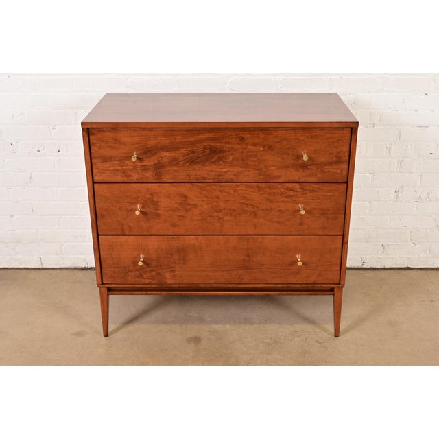 A sleek and stylish Mid-Century Modern three-drawer dresser or chest of drawers By Paul McCobb for Winchendon Furniture,...