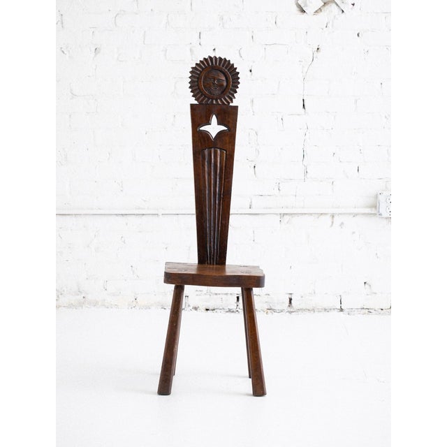 French Brutalist stool, circa 1950s, executed in solid wood with expressive hand-carved detailing. The piece features a...