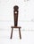 French Brutalist stool, circa 1950s, executed in solid wood with expressive hand-carved detailing. The piece features a...