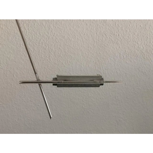 The Wandering Finger is a delicate ceiling light by the lighting designer Ingo Maurer. The thin bar protrudes from the...