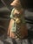 This antique original cast iron doorstop featuring a colonial or Victorian lady in a peachy pink dress and sunflower...