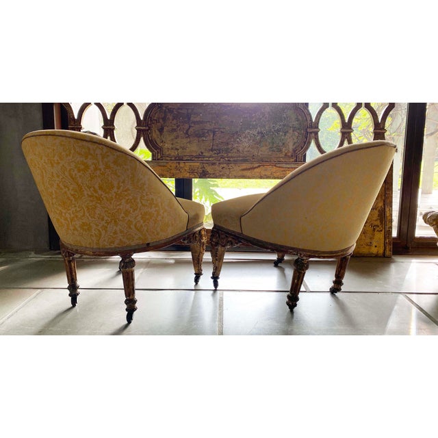 lovely european carved gilded legged pair of chairs on casters. pillow not included.