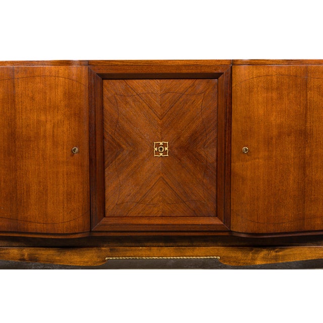 A striking French Art Deco sideboard sourced in Paris, France, dating to the 1930s. Crafted in richly figured walnut...