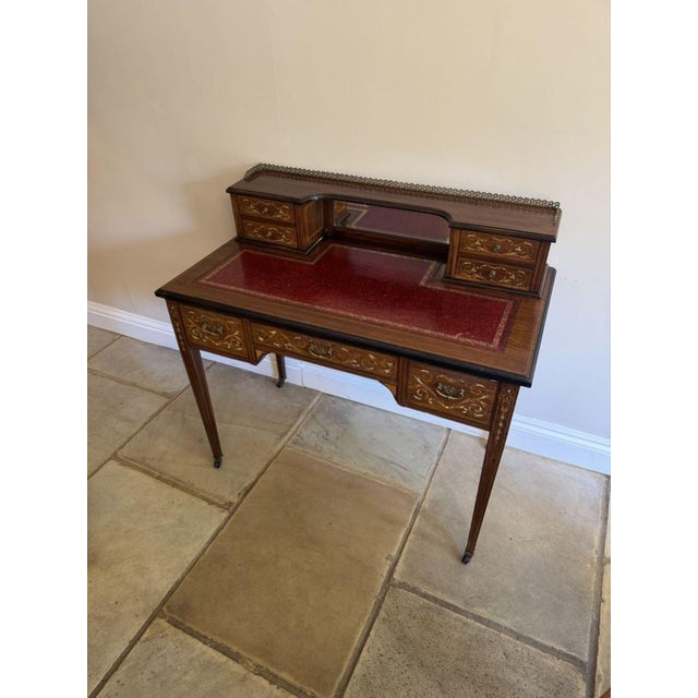 Antique Victorian quality rosewood inlaid writing desk, having the original brass gallery, bevel edge mirror flanked by...