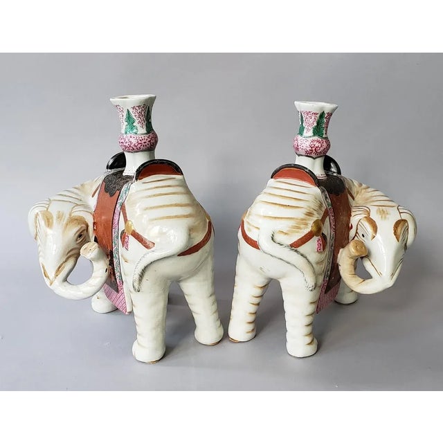 Pair of mirror image porcelain elephant candle holders by Mottahedeh for the DuPont Winterthur Museum. These elephants are...