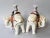Pair of mirror image porcelain elephant candle holders by Mottahedeh for the DuPont Winterthur Museum. These elephants are...