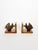Decorative pair of French bookends from the 1960s featuring finely carved stylized fish mounted on warm-toned wooden...