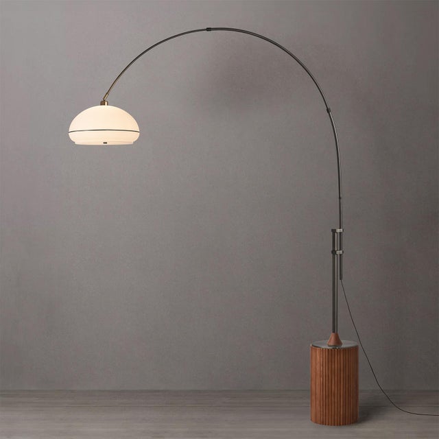 The Tambo Arc Lamp is a striking piece of functional art, featuring a sleek black nickel steel body and a unique Oval...