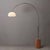 The Tambo Arc Lamp is a striking piece of functional art, featuring a sleek black nickel steel body and a unique Oval...