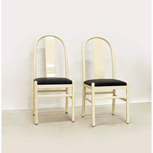 Unique set of four 1980s chairs, entirely made of lacquered wood and featuring a faux leather-padded seat. Defects shown...