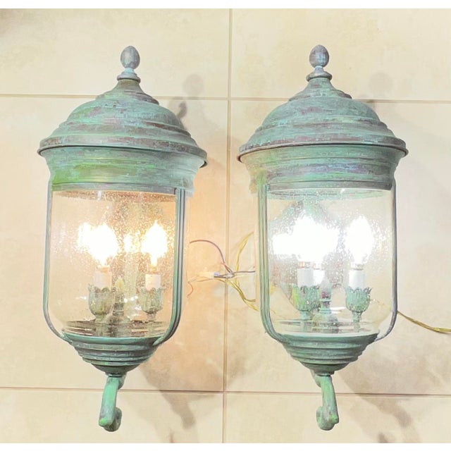 Elevate your home’s exterior or entryway with this spectacular, matching pair of heavy, solid brass wall-mounted lanterns....
