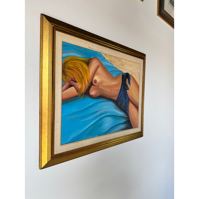 A striking 1998 vintage oil on canvas painting by artist Virginia Ausa, depicting a reclining nude blonde woman resting on...