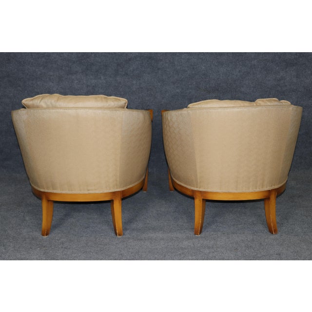 This striking pair of French Art Deco style club chairs, created in the manner of Mario Buatta, carries both structure and...