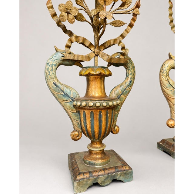 A highly decorative near pair of Italian polychrome and parcel-gilt torchère candelabra, conceived in a theatrical...