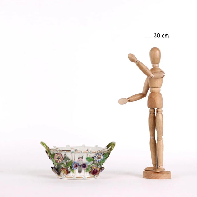 Porcelain openwork basket with gold decoration and embossed flower sprigs. Unidentified maker's mark under base. This...