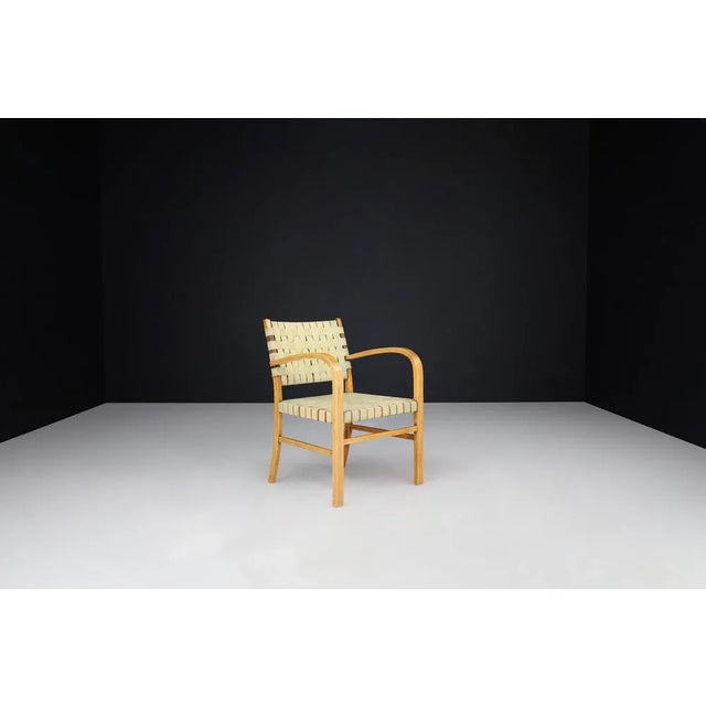 Mid-Century Modern Armchair in Beech and Patinated Canvas Webbing, France, 1950s A charming and authentically patinated...