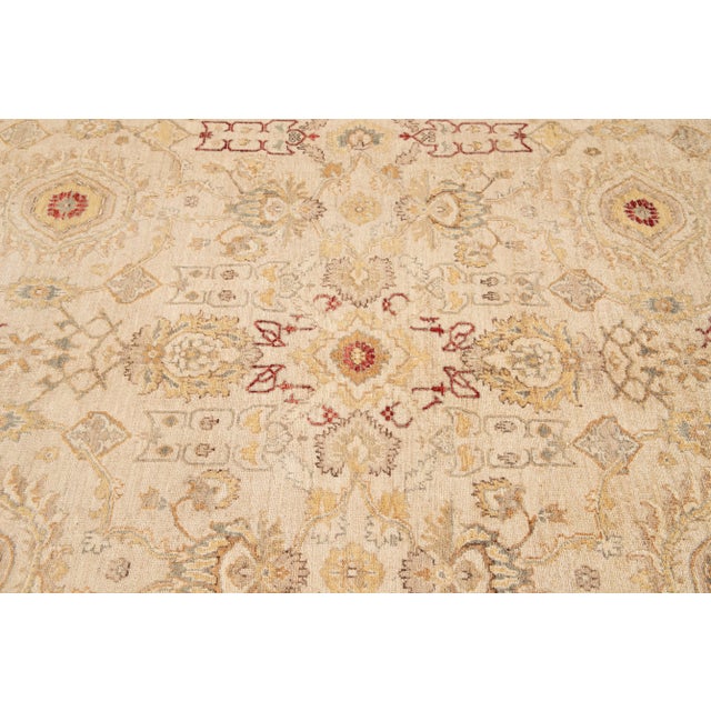 Beautiful contemporary Paki Peshawar rug, hand-knotted wool with a beige field, and multi-color accents in an all-over...
