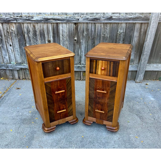 A striking pair of Art Deco bedside tables, thoughtfully repurposed from a vintage waterfall vanity. Each narrow, three-...