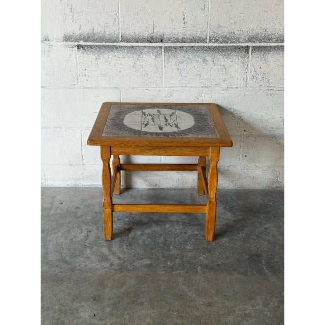 This charming end table features an inset decorative ceramic tile top and sturdy turned legs. Compact in scale, it brings...