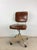 This mid century industrial office chair features steel frame, vintage brown vinyl upholstery, adjustable seat and back...