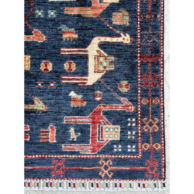 Afghan camel caravan design rug. Hand-knotted in Afghanistan in hand-spun lambswool, after the pictorial weavings of the...