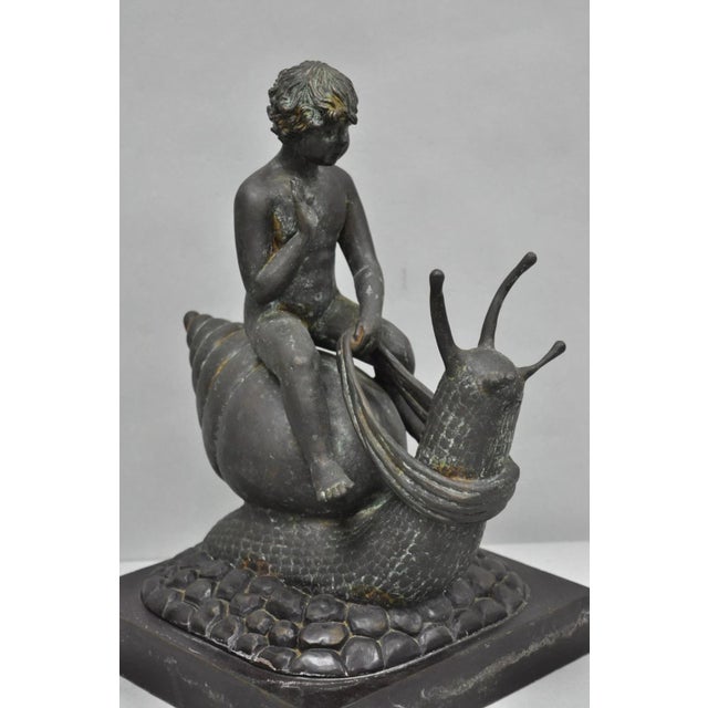 Vintage Mythical Bronze Cherub Riding Snail Sculpture Figure attributed to Maitland Smith. Item weighs approximately 20...