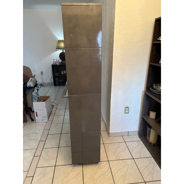 This is our 4-level brushed steel finished bookcase. It has separate stackable units, and features sliding glass doors....