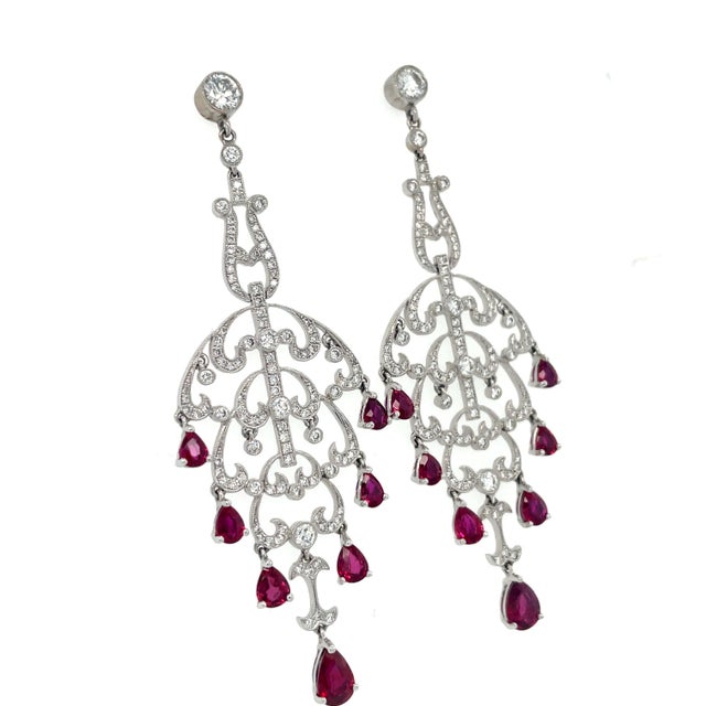 These romantic earrings in a swirling openwork design contain 115 top quality round brilliant cut diamonds weighing...