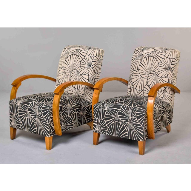 This pair of Art Deco armchairs features curved bentwood arms in golden birch with visible figuring throughout. Frames...