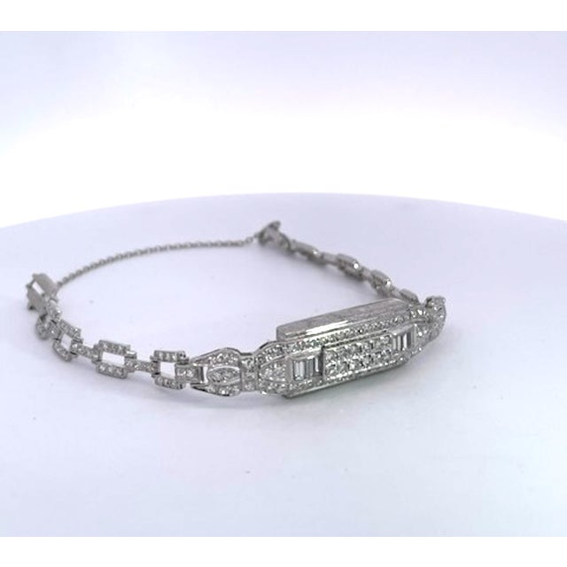 This exquisite Art Deco-style diamond bracelet is crafted in gleaming white platinum and set entirely with brilliant-cut...