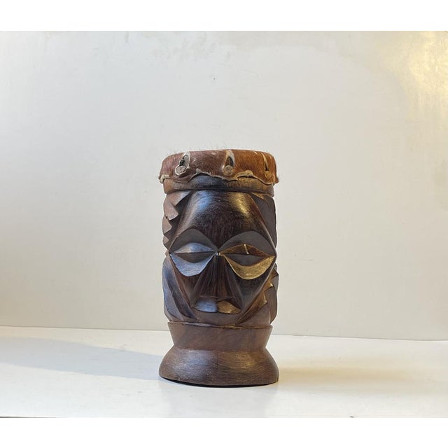 A decorative double-head bust that drums as well. Carved from one lumb of dark wood and featuring a cowhide drum. It was...