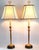 Offering a luxurious pair of RESTORED candlestick table lamps with pale yellow silk vintage shades, circa 1960s. These...