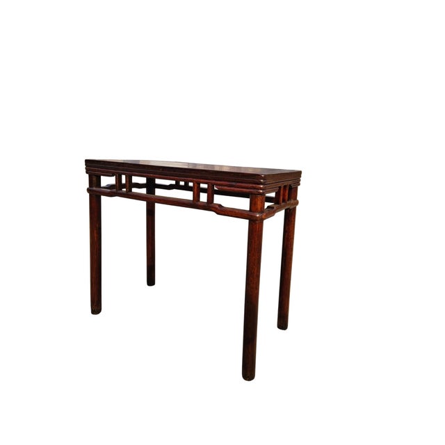 This mid 19th century antique console table features a minimalist, architectural open-frame design with a rich, dark...