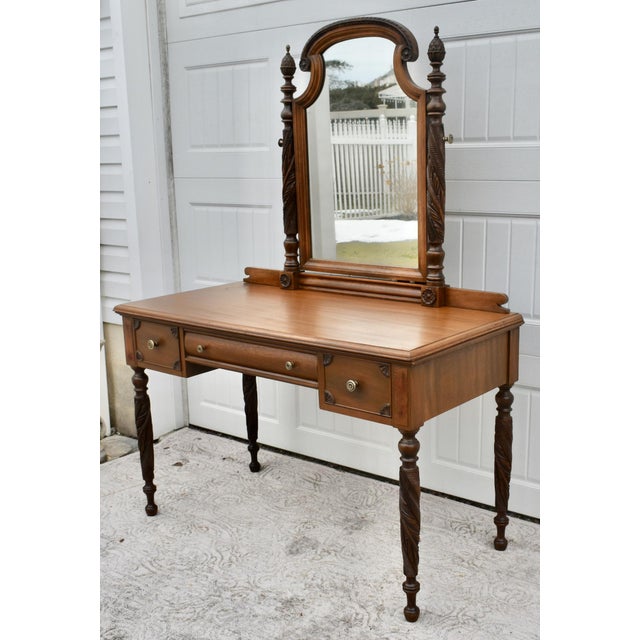Antique (1920's) Vanity & Mirror has a Regency Style. The Wood is Mahogany. The Vanity has Three Drawers, Carved Legs, and...