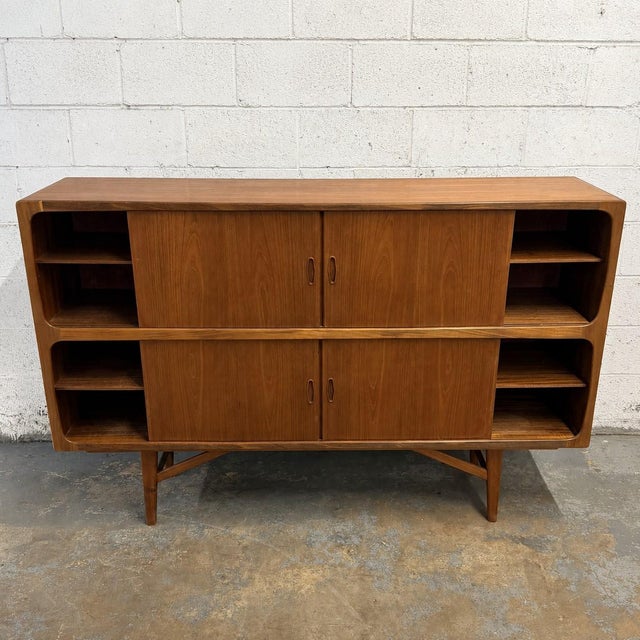 This large Danish teak double highboard has a really impressive presence, both in scale and design. The cabinet has a...