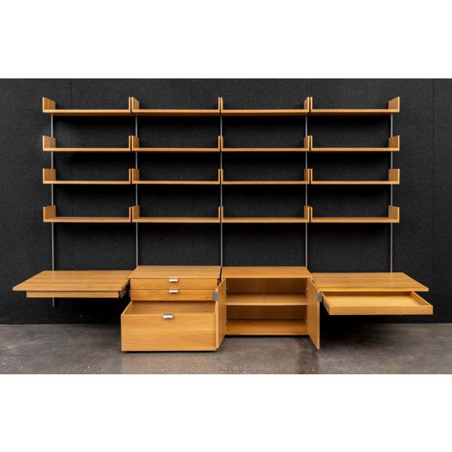 Atlas Walnut Wall-Mounted Shelving Unit, with 16 short shelves above two door cabinet and three-drawer chest flanked by...
