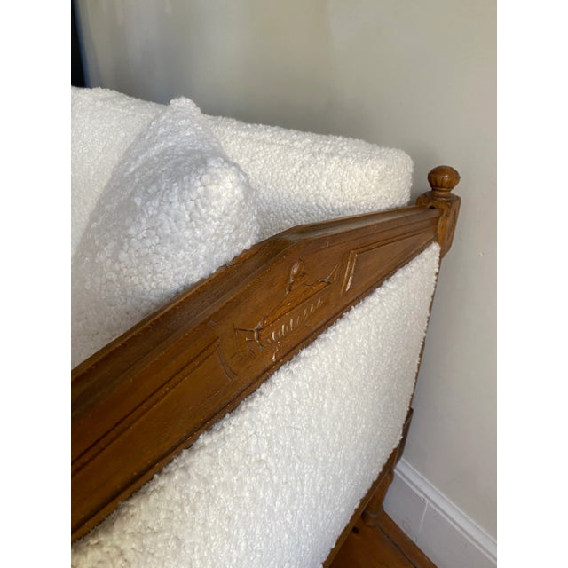 Neoclassical style daybed / settee having carved details throughout, all new upholstery in Boucle.