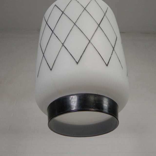 Stylish lantern-shaped lamp with a soft light and a decorative black pattern. height: 50 cm. ø: 18 cm. shade height: 28...