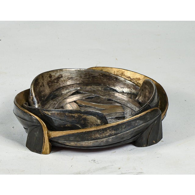 Ashtray, emptychocked, signed Brumel made of resin covered with gray and gold metal, round shape created by the direction...