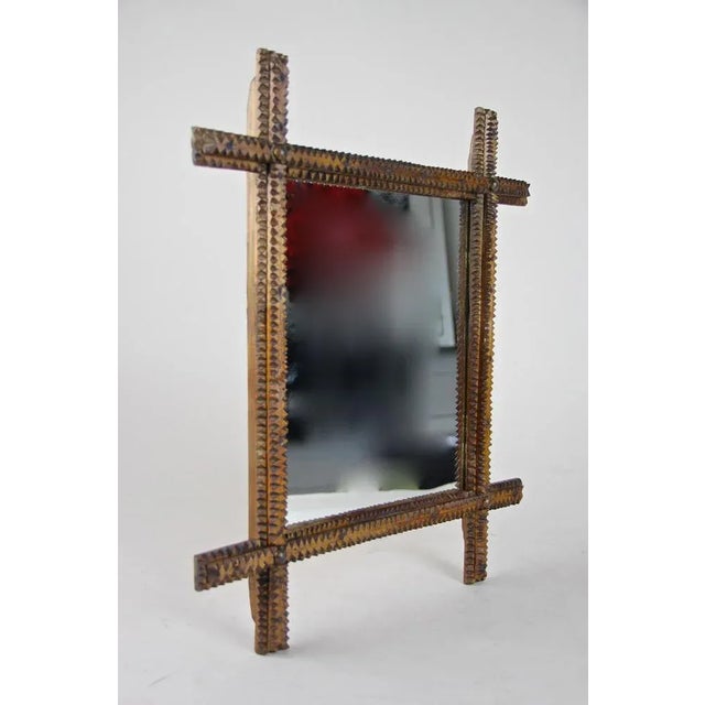 Lovely hand carved rustic wall mirror in beautiful Tramp Art design from Austria circa 1870. This late 19th century wooden...