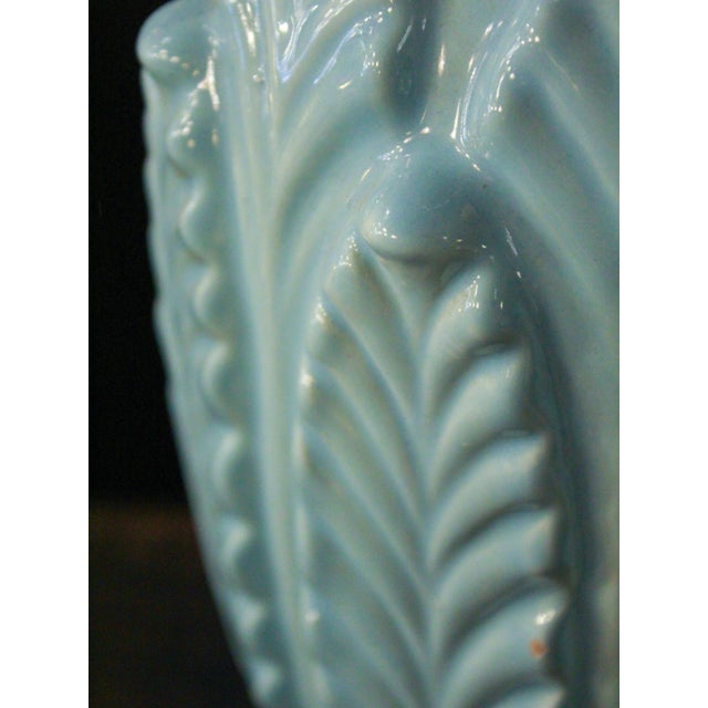 Vintage ceramic table lamp from Manises, in an elegant sky blue. It features an ornamental design with delicate leaf...
