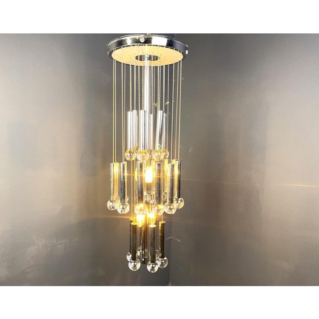 Large cascading chandelier by Gaetano Sciolari with chromed tubes and glass beads. The multi height levels create a nice...