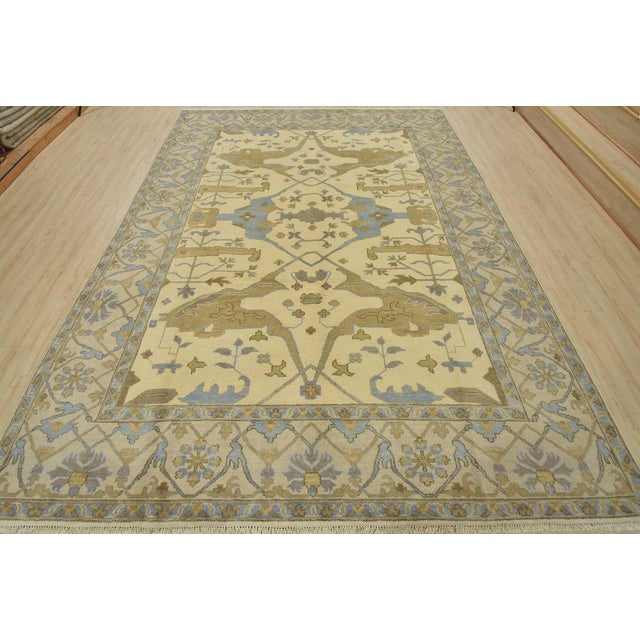 This traditional tribal Oushak rug is hand-knotted with an all-wool pile on a cotton foundation. This rug is new and in...